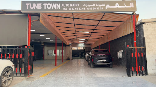 Tune Town Auto Maintenance entrance and sign, with the workshop driveway and cars